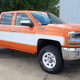 A new Chevrolet Silverado with a classic color scheme and wheels, Cheyenne Super 10 labels and Big 10 decals, customized by a Minnesota dealer.